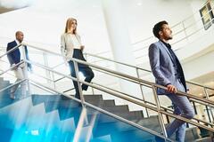 office workers walking down a flight of stairs with an amount of distance