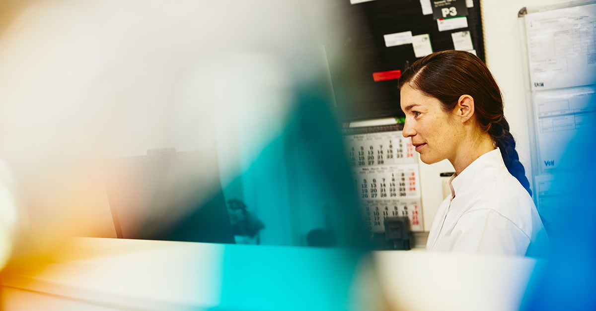A photo of a woman working behind a desk in the public sector industry.