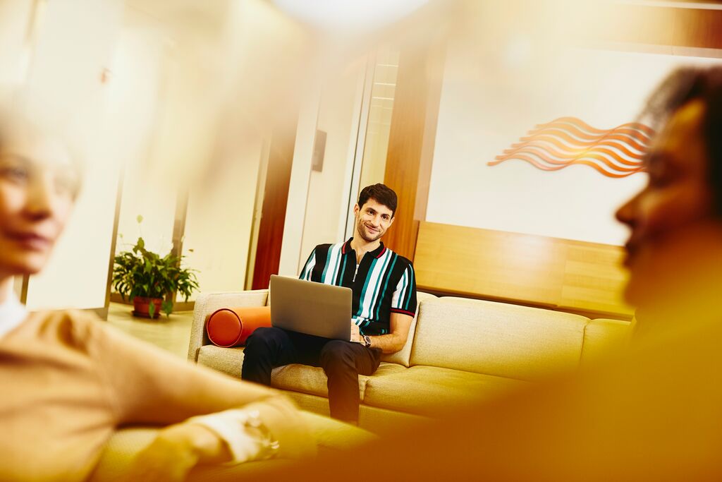 A photo of a man typing something on his laptop