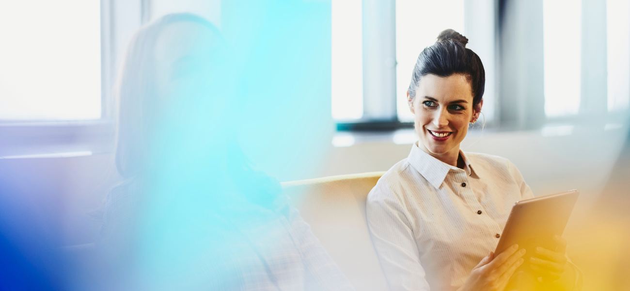 an image of a woman talking to her colleague