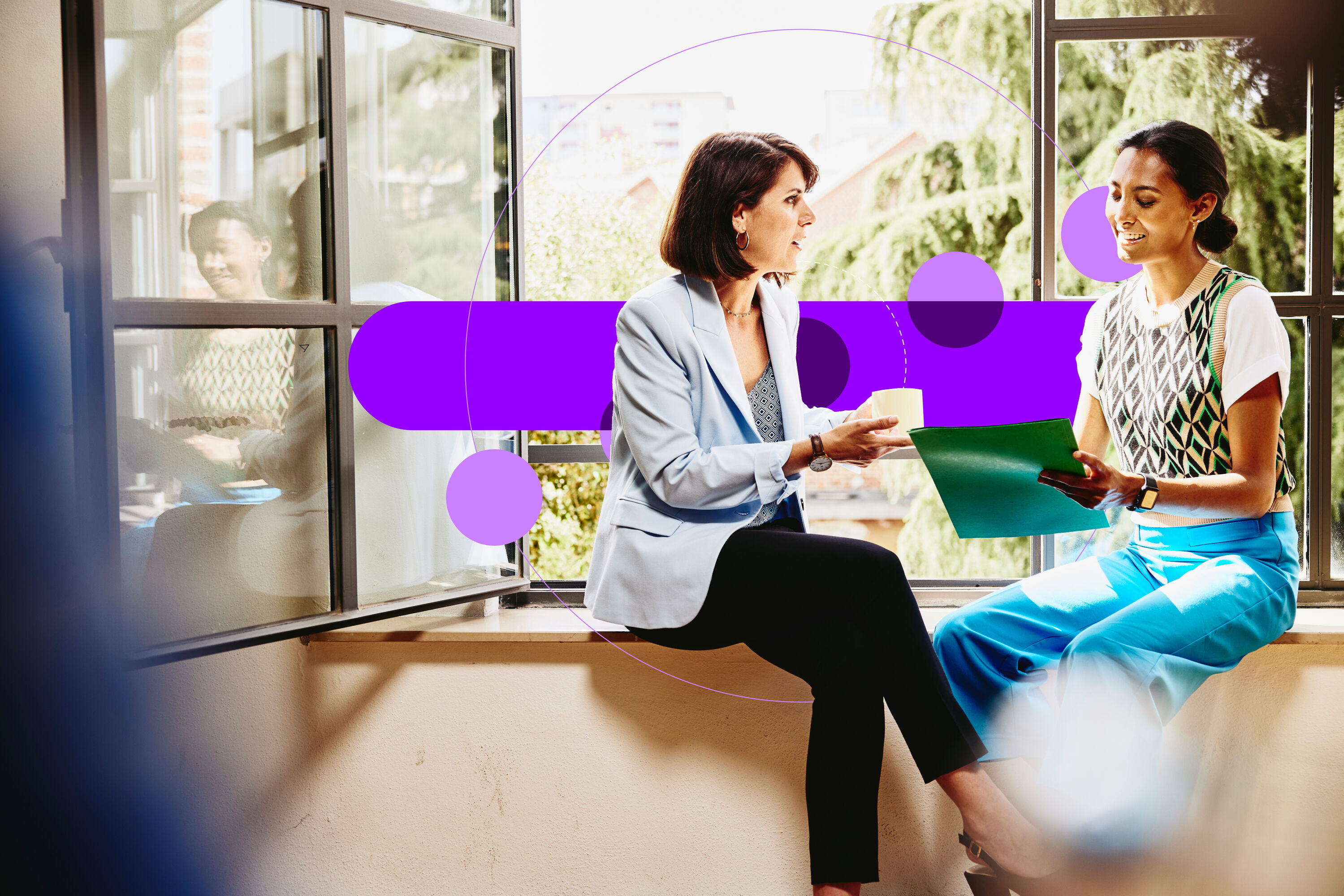 an image of two female sitting on a window sill looking at papers