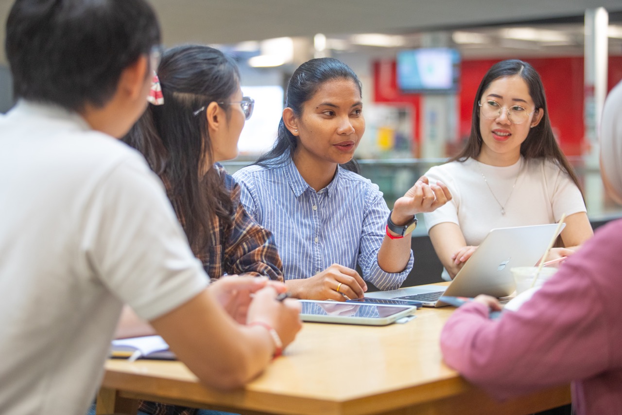 person speaking to a group of people
