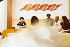 an image of workers casually chatting and smiling in a break room