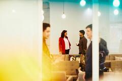 office workers chatting in a break room