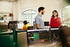 an illustration of an office environment with two people chatting in the front