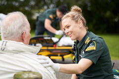 an image of a blonde woman checking on an elderly