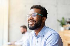 image of a male worker smiling in an office setting