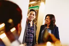 Group having a conversation. Smiling. Office setting.
