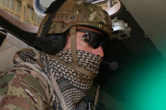 a soldier wearing his uniform and glasses