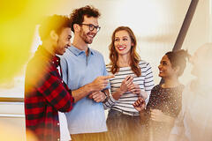 an image of a group of people talking and smiling