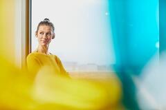a woman wearing a yellow top smiling