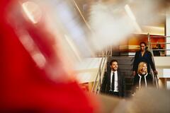 an image of people walking down the stairs while smiling