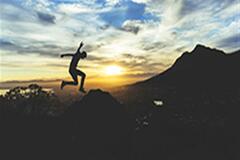 an image of a jump shot of a person in the mountains