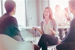a woman discussing something with her colleagues