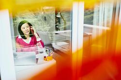 A photo of a woman on the phone working as an executive assistant