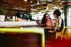 Two women chatting at a cafe