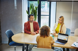 people working in an office boardroom