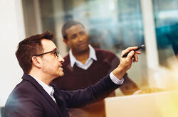 Two men working together in an office