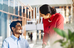 an image of a man smiling brightly at his colleague