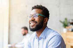 image of a male worker smiling in an office setting