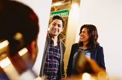 Group having a conversation. Smiling. Office setting.
