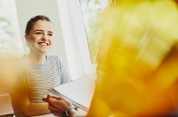 a young woman smiling at her friend