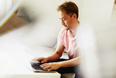 a man typing in his laptop