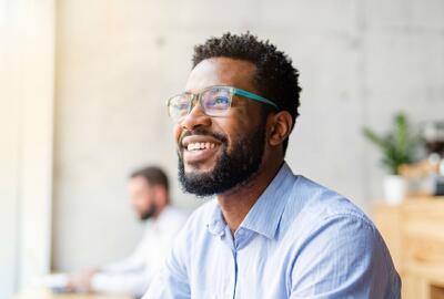 image of a male worker smiling in an office setting