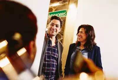Group having a conversation. Smiling. Office setting.
