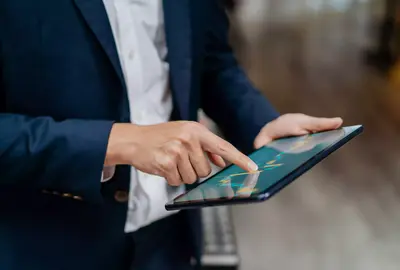 Image of an businessman checking stock market chart on digital tablet. Fund manager looking at stock market chart on digital tablet.