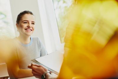 a young woman smiling at her friend