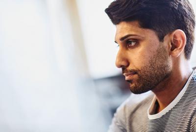 a man wearing a stripped shirt looking to the left