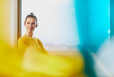 a woman wearing a yellow top smiling