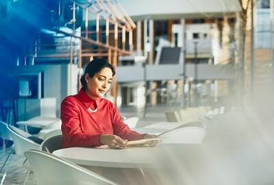 a woman looking at something she is holding while seated