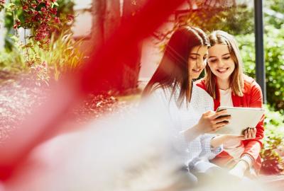 two young women looking at a tablet