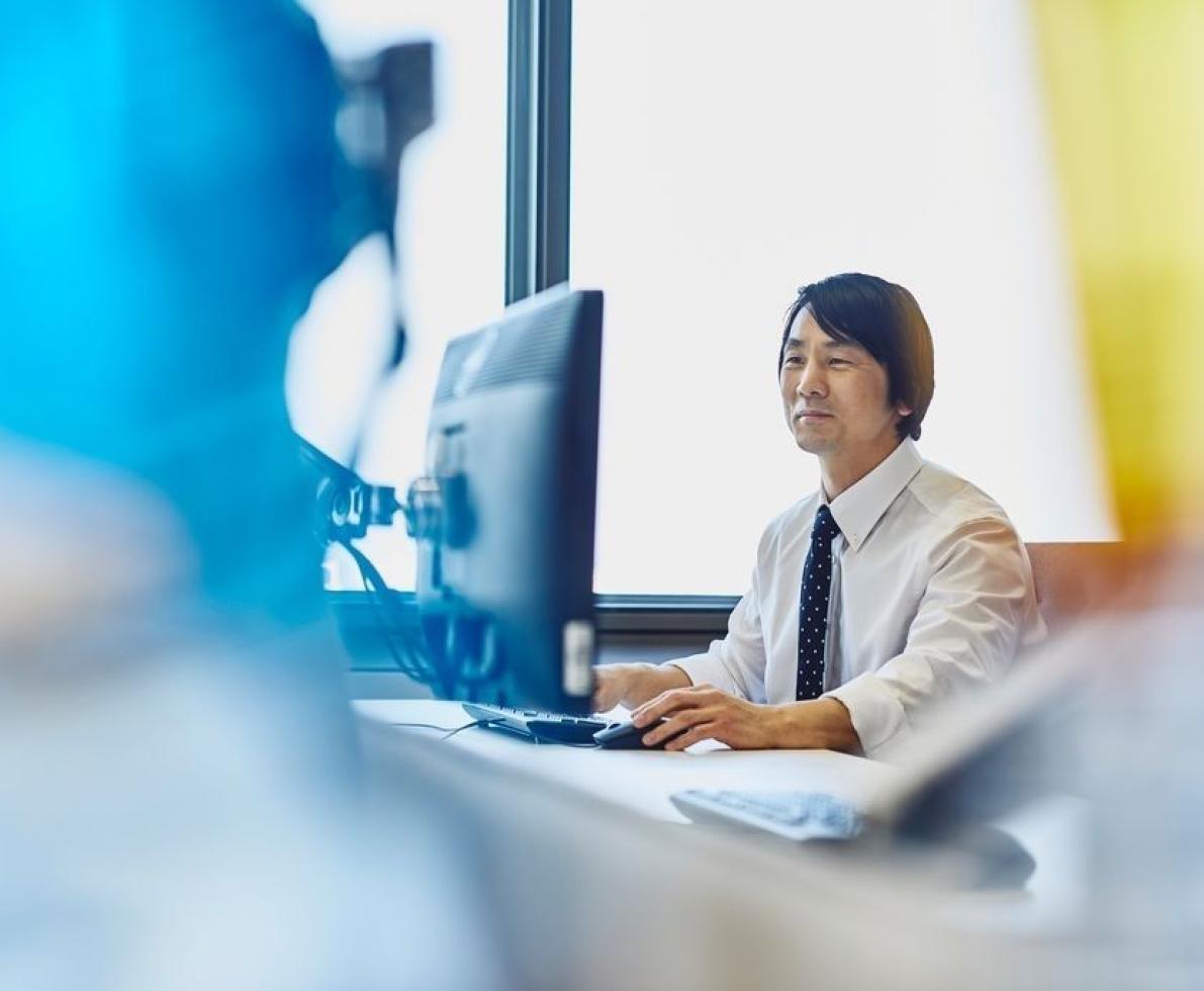 a man looking at his computer screen working