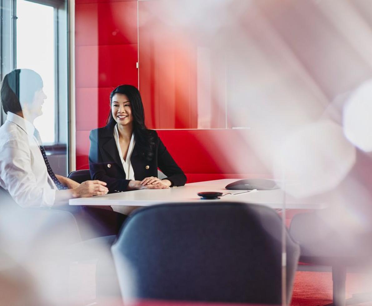 Man and woman talking in an office Man and woman talking in an office