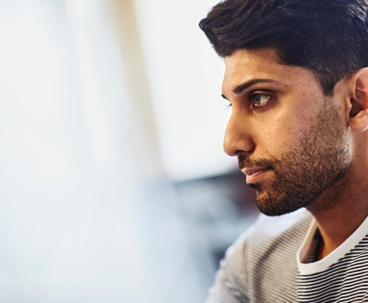 A close-up photo of a man working as a solutions architect