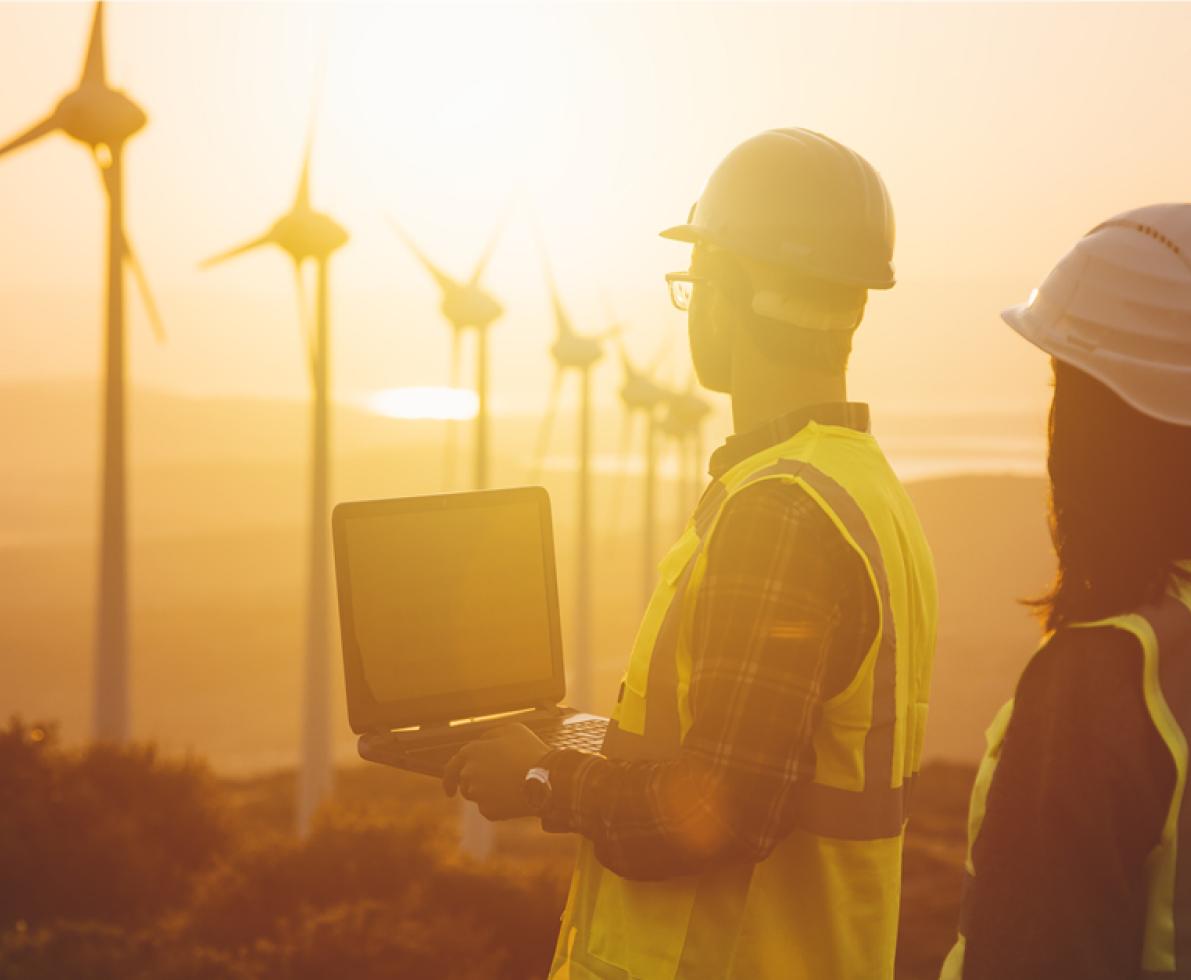 A photo of two people working as wind and solar engineers