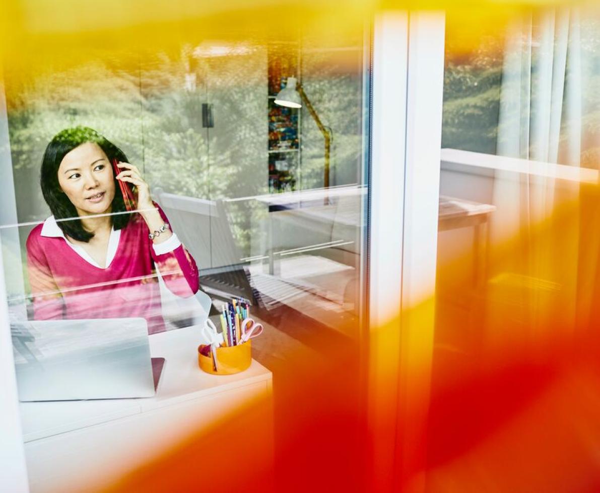 A photo of a woman on the phone working as an executive assistant