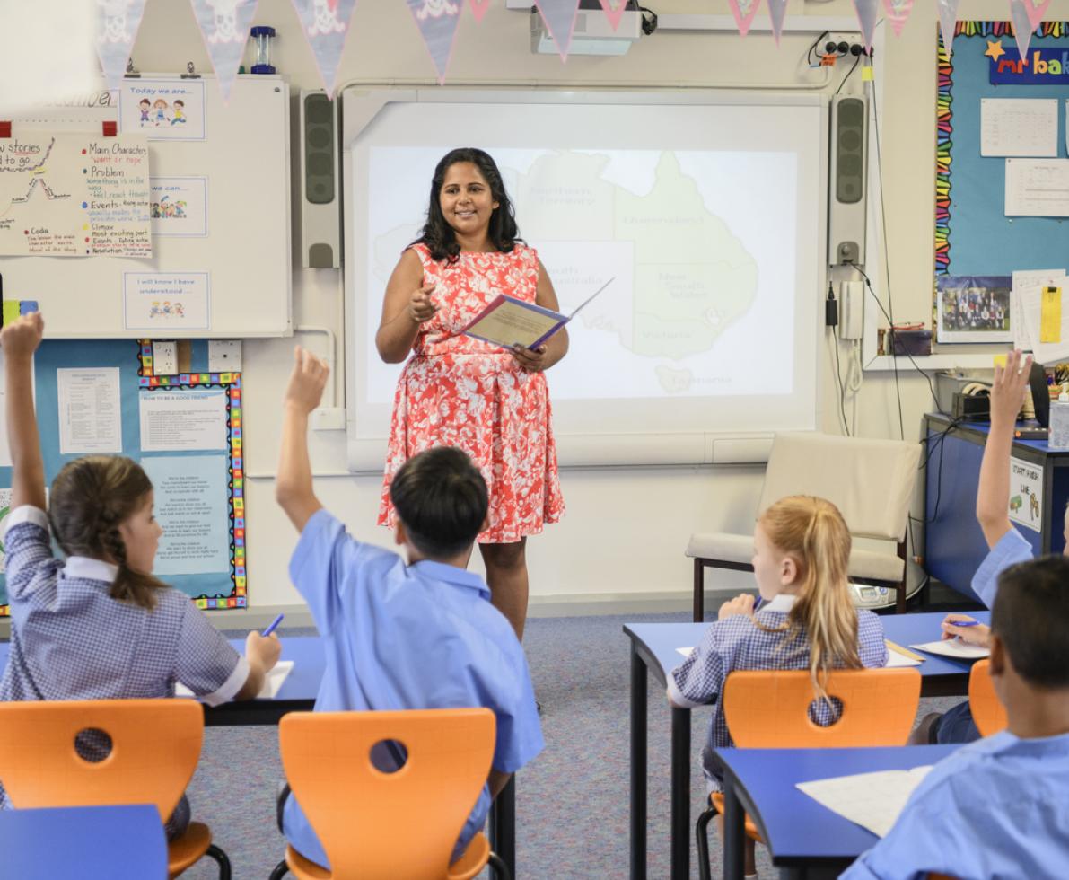 A photo of a young woman teaching kids in the classroom