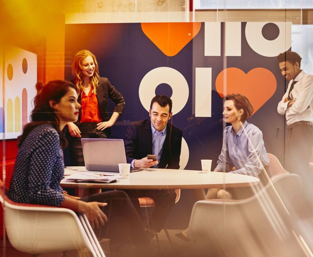 an image of employees collaborating in the office