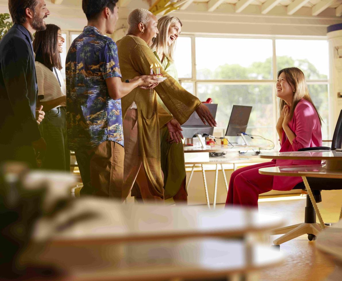 A photo of Agnes being welcomed and celebrated by her colleagues at work