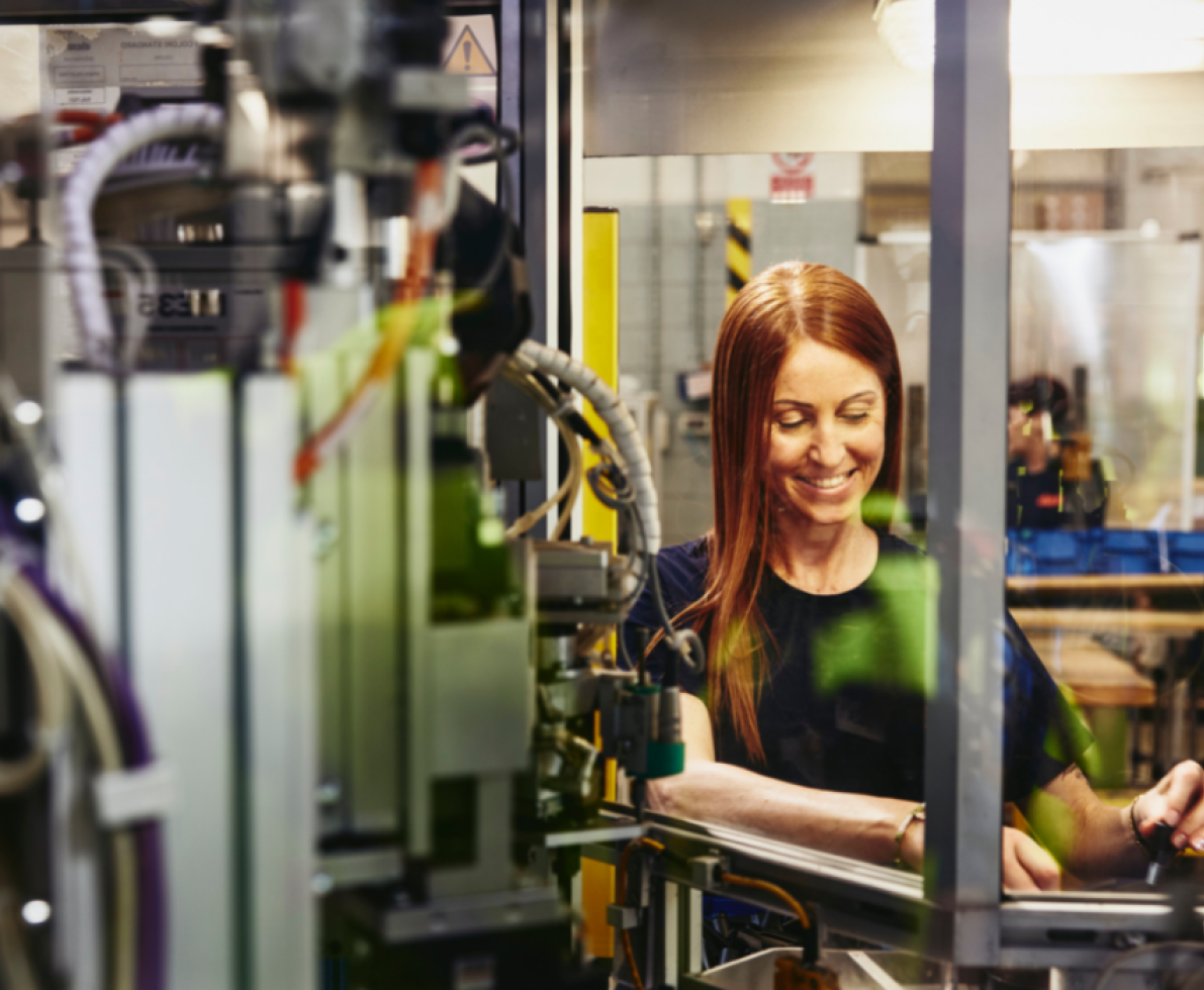 a image of a woman working on a machine a image of a woman working on a machine