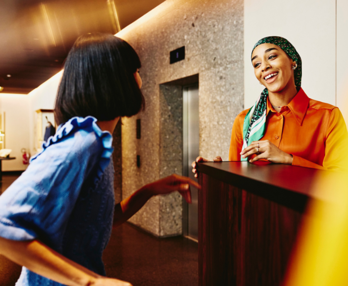 two women talking in the reception table