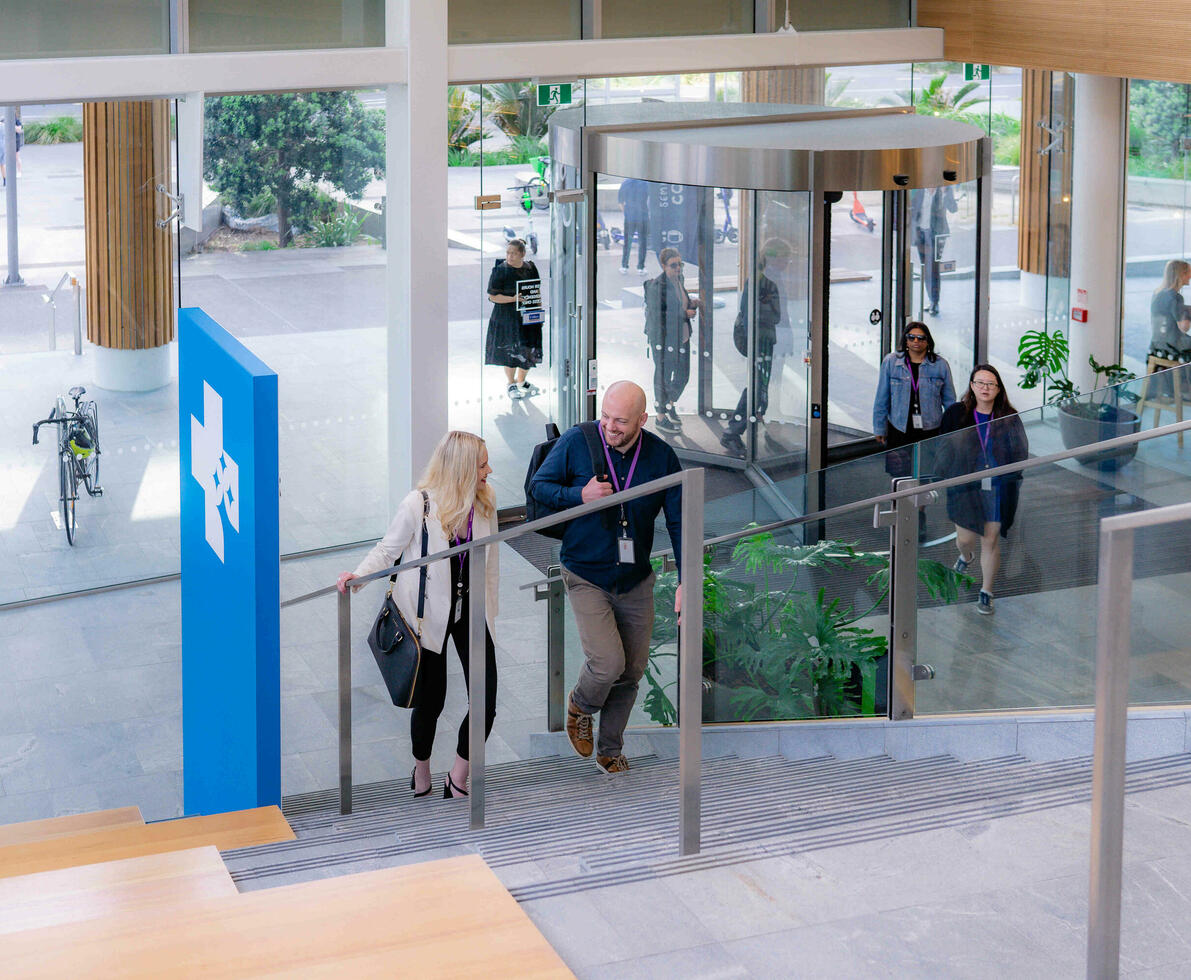 Office workers climbing stairs while chatting