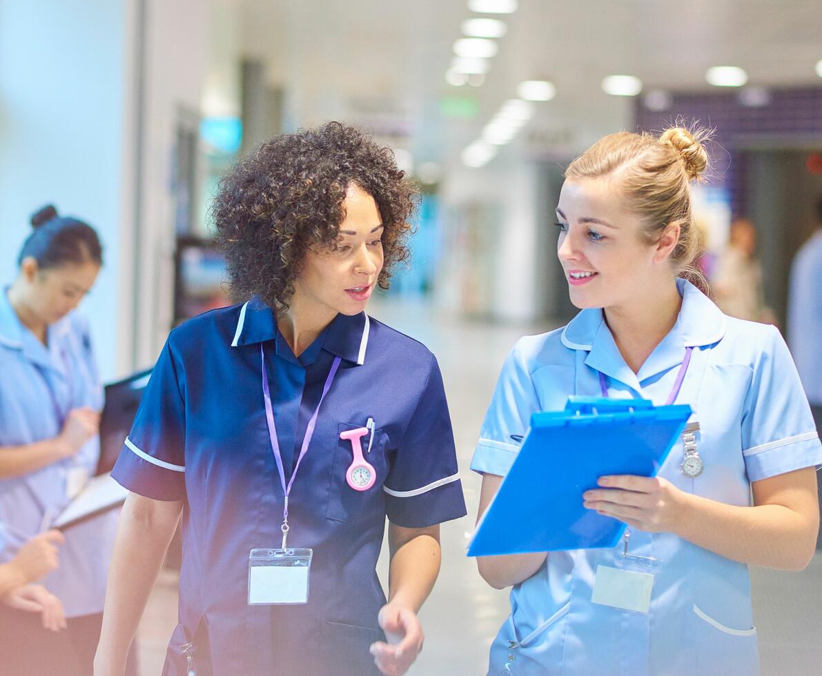two nurses having a conversation two nurses having a conversation