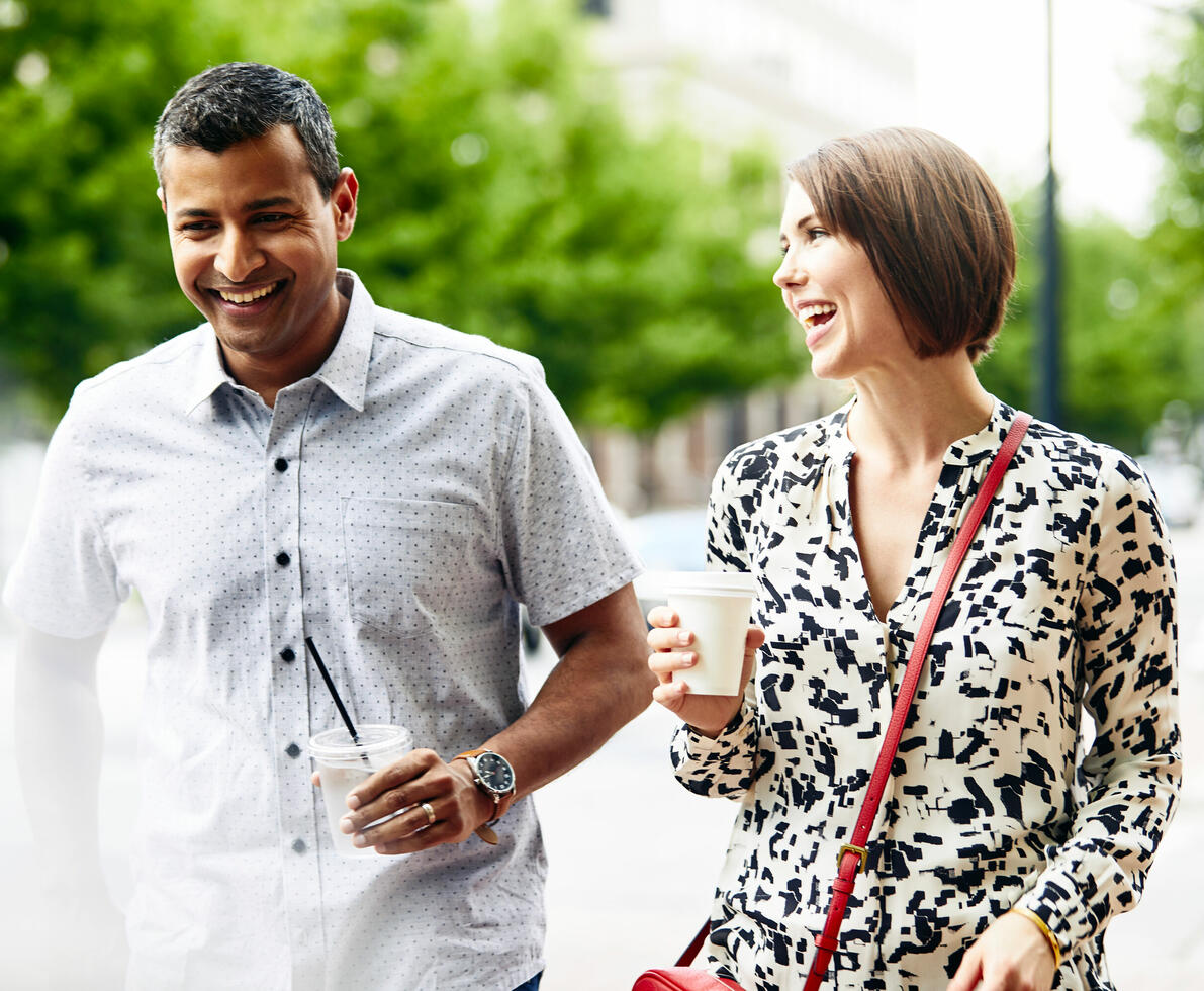 man and woman having a friendly chat drinking water and coffee