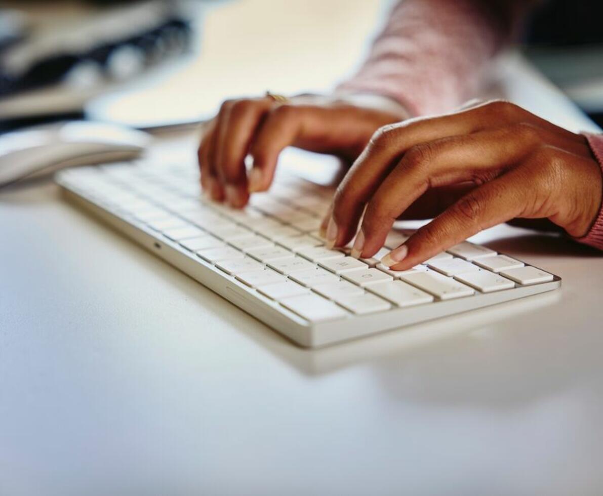 an image of hands typing on a keyboard