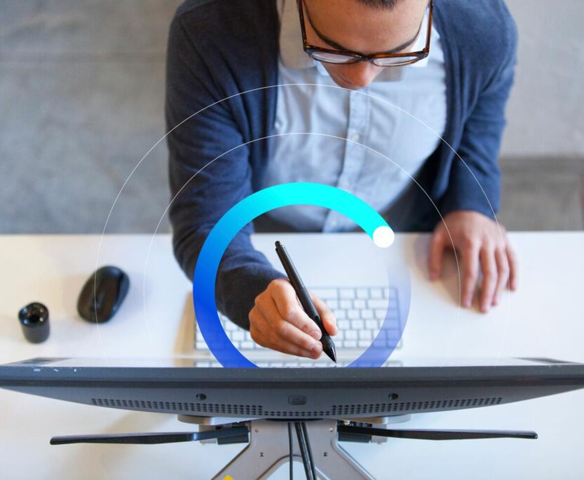 an image of a woman using a stylus for her monitor